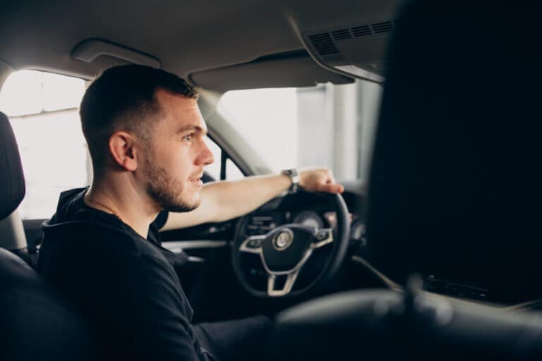 Man with short hair and beard driving car, focused on the road. Man with short hair and beard driving car, focused on the road.