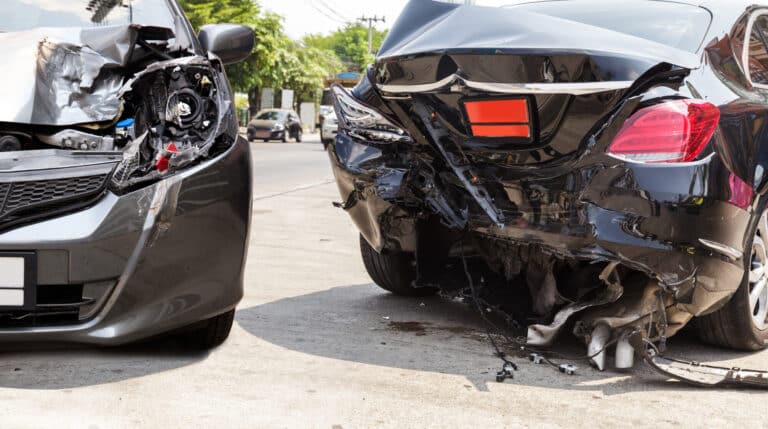 Two badly damaged cars after a crash on a sunny road. Two badly damaged cars after a crash on a sunny road.