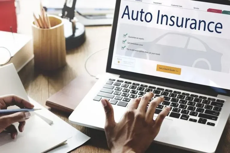 Laptop shows auto insurance site and “Request a quote” button; desk has papers, pen, cup.