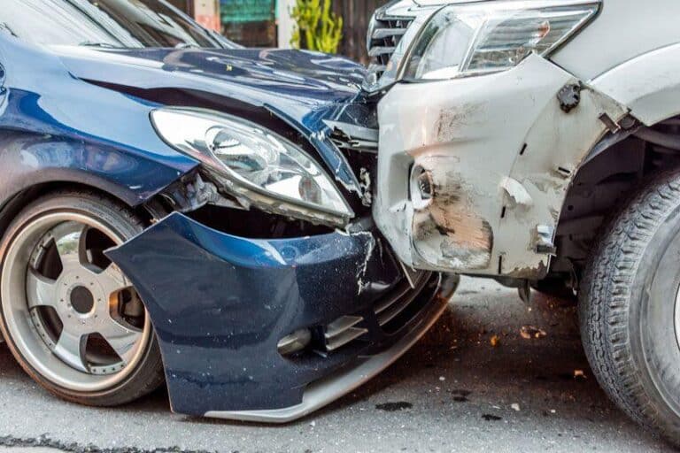 Blue car and silver SUV with heavy front-end collision damage. Blue car and silver SUV with heavy front-end collision damage.