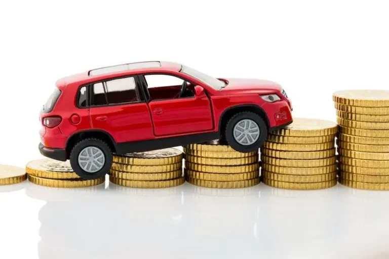Red toy car atop rising stacks of gold coins, showing increasing car expenses.