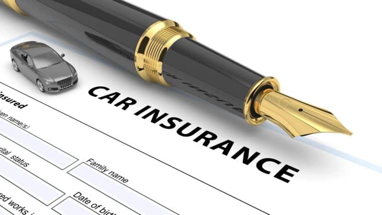 Fountain pen and toy car atop a blank car insurance form. Fountain pen and toy car atop a blank car insurance form.