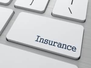 Keyboard key labeled Insurance in black letters stands out among standard keys.
